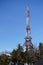 Vertical. transmitter and repeater signal in the woods against the blue sky and clouds, vertical. Telecommunication tower with