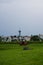 Vertical of a Trondheim skyline with siege red cannon and green grass.