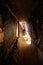 VERTICAL: Unrecognizable woman walks up a flight of stairs inside Mati temple.