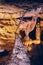 Vertical of unusual cave formations stalagmites and stalactites joining