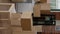 Vertical video: Empty apartment flat full of moving unpacked cardboard boxes