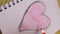Vertical video of love heart on notebook with pen