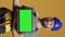 Vertical video: Portrait of repairman holding laptop with greenscreen display