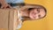 VERTICAL VIDEO POV closeup portrait happy young blonde woman holding craft wrapped gift box