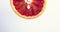 Vertical Video. Rotating grapefruit half. Vitamins, healthy dieting eating concept, close up. Copy space