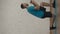 Vertical video. Side view. Man fitness instructor in sportswear doing lunges cross jumps exercise for online class at