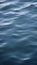 Vertical video of slow blue waves on the lake