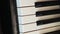 Vertical video, smooth camera movement, selective focus, close-up of piano keys
