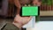 Vertical video: Startup worker using isolated greenscreen on mobile phone