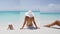 Vertical Video - Travel vacation girl in white bikini relaxing on tropical beach