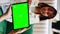 Vertical Video Traveler checking isolated greenscreen template on tablet