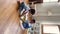 Vertical view African siblings play together wooden railroad toy set