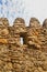 Vertical view of ancient castle  battlements-protective tooth shaped parapets with merlons and crenels for soldiers to shoot from