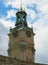 Vertical view of the bell tower of the Cathedral of St. Nicholas Storkyrkan at twelve o`clock. Stockholm, Sweden