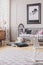 Vertical view of black and white map in frame above wooden crib with pillows, real photo with carpet on the wooden floor