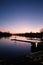 Vertical view of a calm river under the beautiful clear sky at sunset