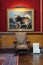 Vertical view of a chair and a dog painting hanging on the wall inside the Belvoir Castle