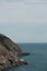 Vertical view of a cliff at the coast of a sea on hazy summer day