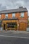 Vertical view of Dublin city street side restaurant building under the cloudy sky