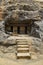 Vertical view of Facade near Cave 12 Vihara showing Stairs, three Cell Doors with rock-cut at Bhaja Caves, Ancient Buddhist built