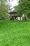 Vertical view of a meadow and trees with wooden horreo to store grain in Asturias