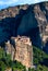 Vertical view of Meteora valley, Greece, midday. Cliff top Moni Agias Varvaras Roussanou nunnery, hills, high