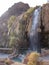 Vertical view of the mountain with waterfall and natural pool in Hammamat Ma`In Hot Springs, Jordan