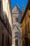 vertical view of narrow Orvieto Streets with the spire of the Orvieto Cathedral behind