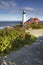 A vertical view of Portland Light in Maine on a beautiful sunny day