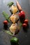 Vertical view of raw pomfret fish along with vegetables on a background.