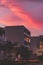 Vertical view of resort buildings under the pink sunset sky in Cancun