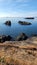 Vertical view of rugged cliffs in clear waters of the Rosario Head Trail in Washington, America