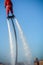 Vertical View of Santa Claus on Flyboard on Blue Sky Background. Taranto, Italy