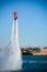 Vertical View of Santa Claus on Flyboard on Blur Background