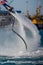 Vertical View of Santa Claus Flying on Flyboard on Blur Background