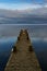 Vertical view of seagulls perching on the dock under the cloudy sky