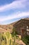 Vertical view of a stone house with a cactus in the foreground in the village of Patones de Arriba in Madrid, Spain. Travel