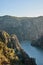 Vertical view of three rocky mountains with cliffs and a river at sunset. Border between Spain and Portugal