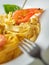 Vertical view to plate with pasta and shrimp with fork