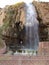 Vertical view of a tourist at the hot spring waterfall and natural pool at Hammamat Ma`In Hot Springs, Jordan