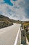 Vertical view of a two-lane road leading over a high remote and wild mountain pass in the Swiss Alps