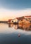 Vertical view of waterside cottages st sunrise