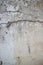 Vertical view of weathered concrete and stucco colonial wall in