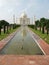 Vertical view. White marble mausoleum surrounded by gardens, fountains and four minarets. Taj Mahal