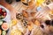 Vertical view of wooden table and people together for breakfast in friendship - brioches and cakes and fruit to start the day -