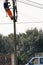 Vertical View of a Worker Repairing a Light Pole With Safety Too