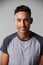 Vertical waist up studio portrait of smiling young man