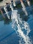 Vertical water streams of dry fountain on main town square, close up view. Kids bare feet near fountain. Summer