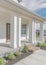 Vertical Whispy white clouds Exterior of a house with white vinyl wood and bricks siding