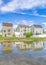 Vertical Whispy white clouds Utah valley community with reflective lake waterfront